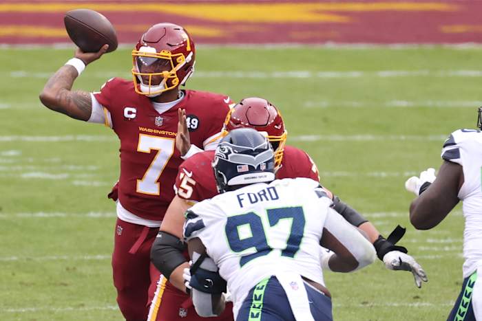 Washington Football Team quarterback Dwayne Haskins Jr. (7) passes the ball as Seattle Seahawks defensive tackle Poona Ford (97) defends in the second quarter at FedExField. The back of Ford's helmet reads, "Breonna Taylor." © Geoff Burke-USA TODAY Sports
